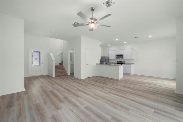 Empty room, Interior, Kitchen, Recessed Lighting, Stainless Steel Appliances, Wood Texture Flooring