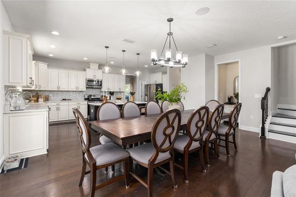 Chandelier, Dining room, Interior, Kitchen, Pendant Lights, Recessed Lighting, Stainless Steel Appliances, Wood Texture Flooring