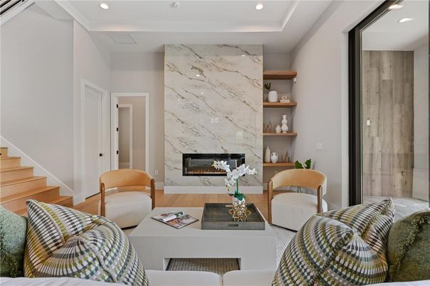 Fireplace, Interior, Living room, Marble Walls, Recessed Lighting, Wood Texture Flooring