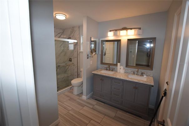 Bathroom, Dual Sink Vanities, Interior, Marble Walls, Wood Texture Flooring
