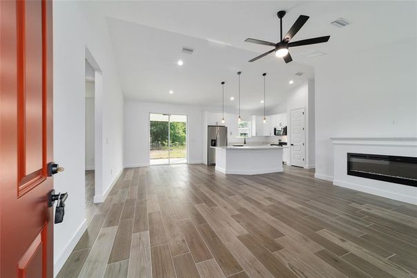 Empty room, Fireplace, Interior, Kitchen, Pendant Lights, Recessed Lighting, Wood Texture Flooring