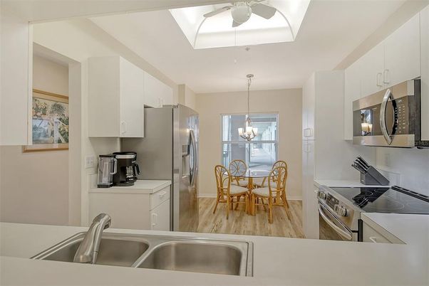 Chandelier, Dining room, Interior, Kitchen, Pendant Lights, Stainless Steel Appliances, Wood Texture Flooring