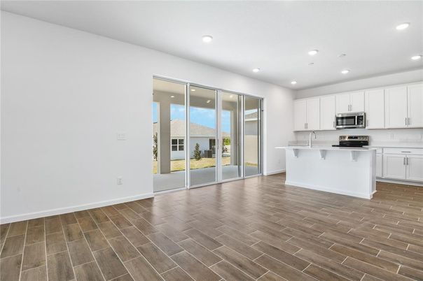 Empty room, Interior, Kitchen, Recessed Lighting, Stainless Steel Appliances, Wood Texture Flooring