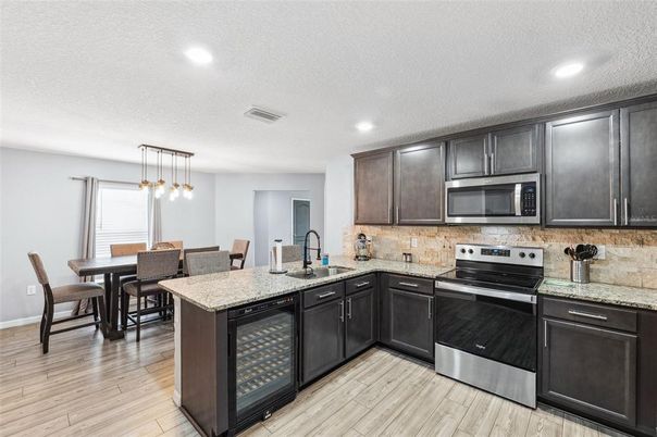 Dining room, Interior, Kitchen, Pendant Lights, Recessed Lighting, Stainless Steel Appliances, Wood Texture Flooring
