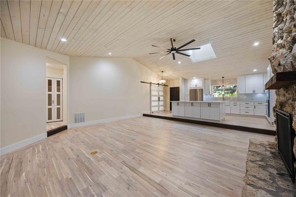 Empty room, Fireplace, Interior, Kitchen, Pendant Lights, Recessed Lighting, Stone Walls, Wood Texture Flooring