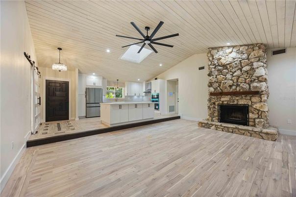 Fireplace, Interior, Kitchen, Living room, Recessed Lighting, Stone Walls, Wood Texture Flooring
