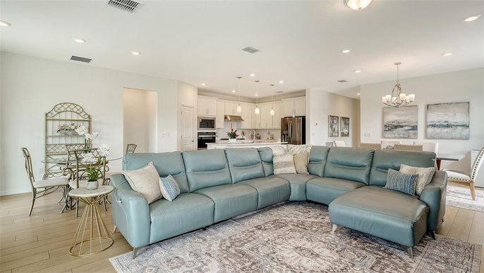 Chandelier, Dining room, Interior, Kitchen, Living room, Pendant Lights, Recessed Lighting, Stainless Steel Appliances, Wood Texture Flooring