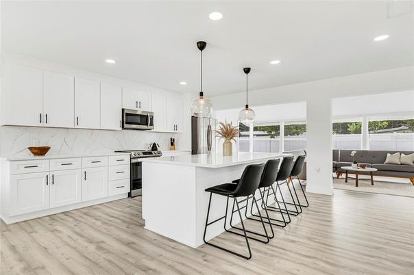Interior, Kitchen, Marble Walls, Pendant Lights, Recessed Lighting, Stainless Steel Appliances, Wood Texture Flooring