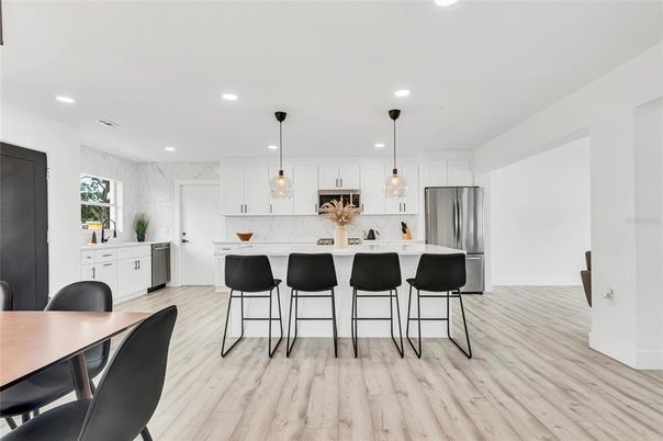Interior, Kitchen, Marble Walls, Pendant Lights, Recessed Lighting, Stainless Steel Appliances, Wood Texture Flooring
