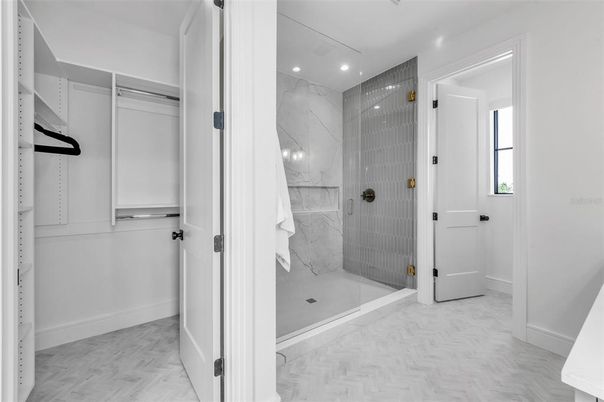 Bathroom, Glass Shower, Interior, Marble, Marble Walls, Recessed Lighting, Walk-in Closets, Wood Texture Flooring