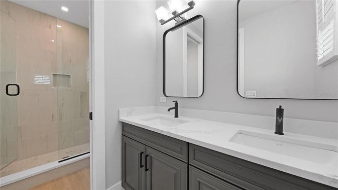 Bathroom, Dual Sink Vanities, Glass Shower, Interior, Recessed Lighting, Wood Texture Flooring