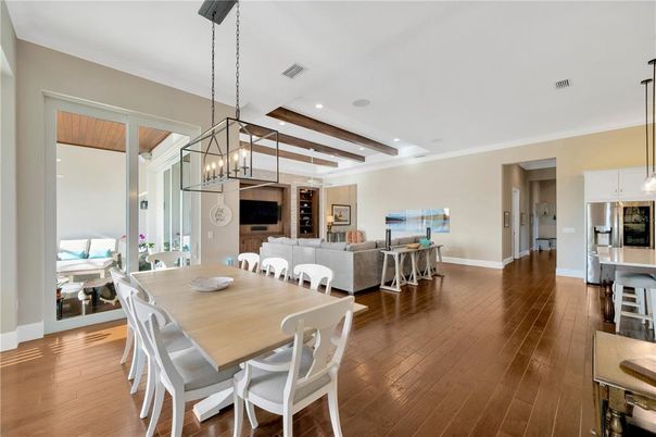 Chandelier, Dining room, Interior, Living room, Pendant Lights, Recessed Lighting, Wooden Beams, Wood Texture Flooring