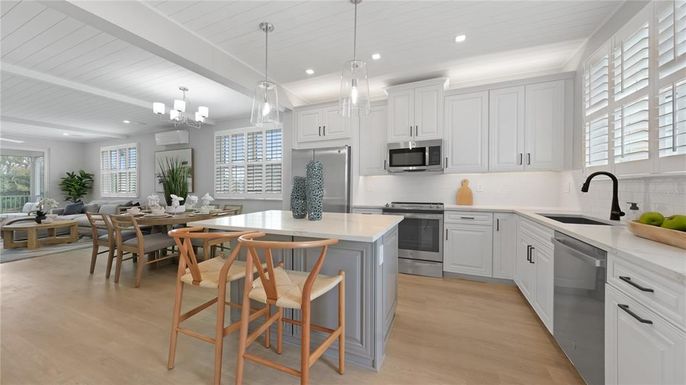 Chandelier, Dining room, Interior, Kitchen, Pendant Lights, Recessed Lighting, Stainless Steel Appliances, Wood Texture Flooring