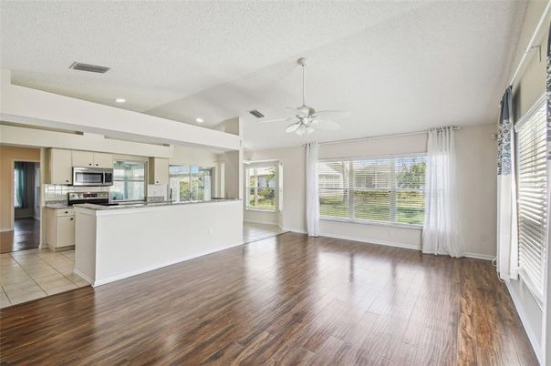 Empty room, Interior, Kitchen, Recessed Lighting, Stainless Steel Appliances, Wood Texture Flooring