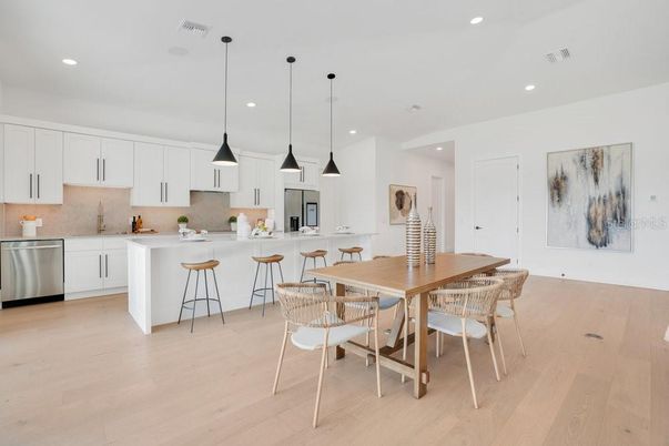 Dining room, Interior, Kitchen, Pendant Lights, Recessed Lighting, Stainless Steel Appliances, Wood Texture Flooring