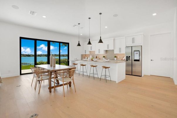 Dining room, Interior, Kitchen, Pendant Lights, Recessed Lighting, Stainless Steel Appliances, Water, Wood Texture Flooring