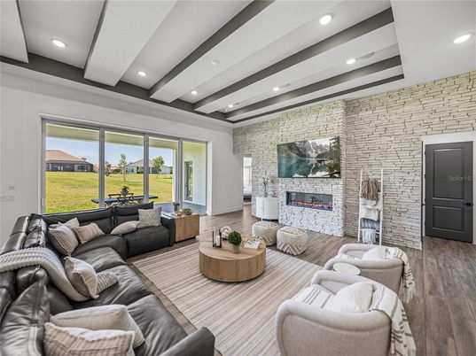 Fireplace, Interior, Living room, Recessed Lighting, Stone Walls, Wood Texture Flooring