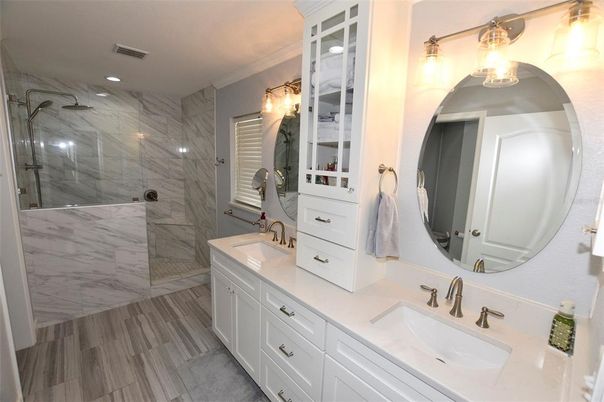 Bathroom, Dual Sink Vanities, Glass Shower, Interior, Marble Walls, Recessed Lighting, Wood Texture Flooring