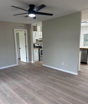 Empty room, Interior, Kitchen, Stainless Steel Appliances, Wood Texture Flooring