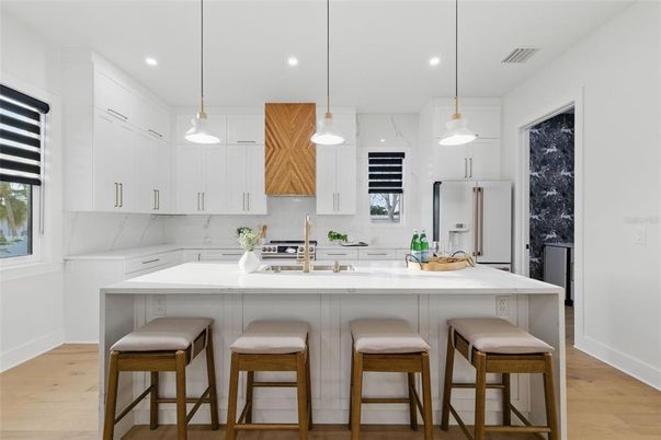 Interior, Kitchen, Marble Walls, Pendant Lights, Recessed Lighting, Stainless Steel Appliances, Wood Texture Flooring