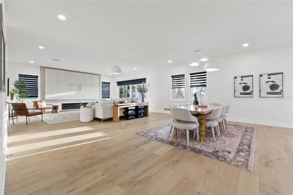 Dining room, Fireplace, Interior, Living room, Pendant Lights, Recessed Lighting, Wood Texture Flooring