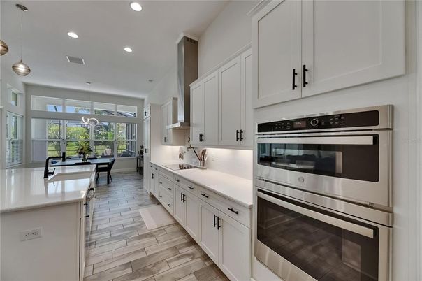 Dining room, Interior, Kitchen, Pendant Lights, Recessed Lighting, Stainless Steel Appliances, Wood Texture Flooring