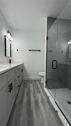 Bathroom, Dual Sink Vanities, Glass Shower, Interior, Tile Countertops, Wood Texture Flooring
