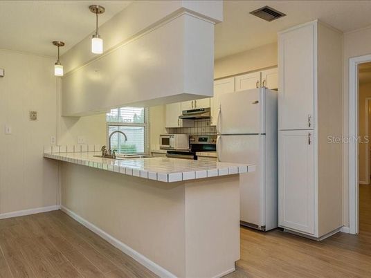 Interior, Kitchen, Pendant Lights, Tile Countertops, Wood Texture Flooring