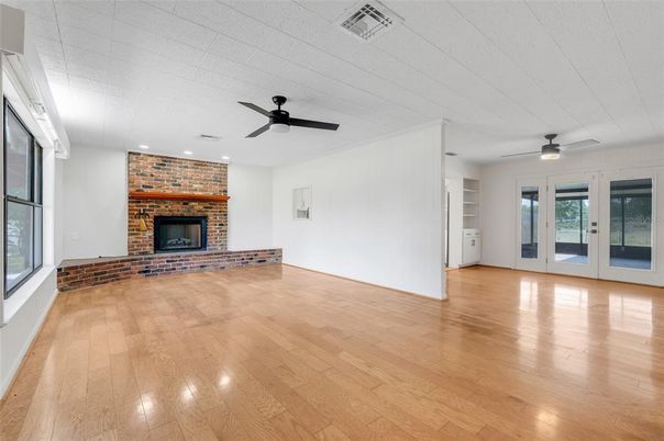 Empty room, Fireplace, Interior, Recessed Lighting, Stone Walls, Wood Texture Flooring