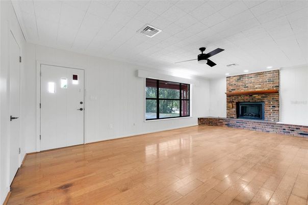 Empty room, Fireplace, Interior, Recessed Lighting, Stone Walls, Wood Texture Flooring