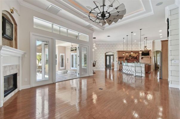 Empty room, Fireplace, Interior, Kitchen, Pendant Lights, Recessed Lighting, Stone Walls, Wood Texture Flooring