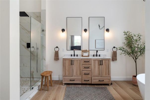 Bathroom, Dual Sink Vanities, Glass Shower, Interior, Marble Walls, Wood Texture Flooring