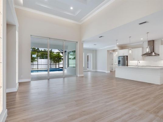 Empty room, Interior, Kitchen, Pendant Lights, Recessed Lighting, Stainless Steel Appliances, Wood Texture Flooring