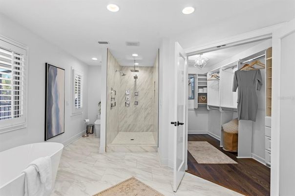Bathroom, Free Standing Baths, Glass Shower, Interior, Marble, Marble Walls, Recessed Lighting, Walk-in Closets, Wood Texture Flooring