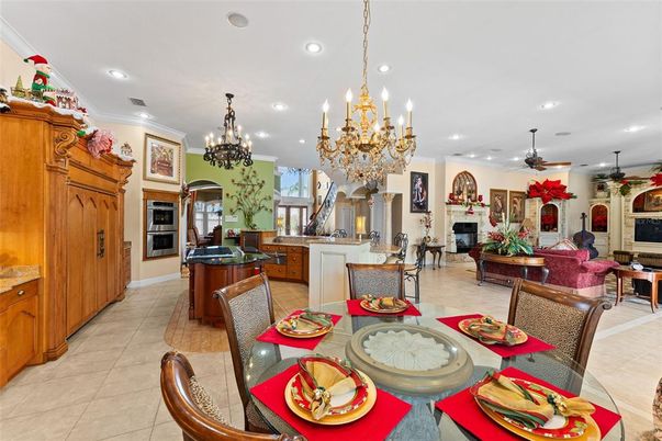 Chandelier, Dining room, Fireplace, Interior, Kitchen, Living room, Recessed Lighting, Stainless Steel Appliances