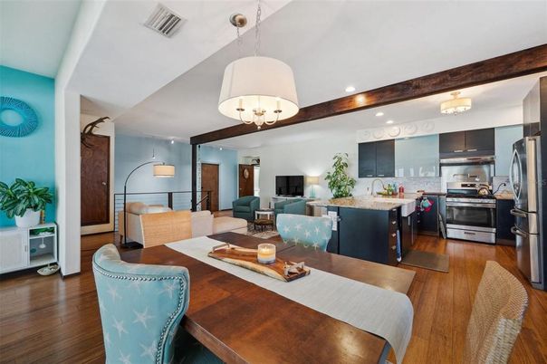 Chandelier, Dining room, Interior, Kitchen, Living room, Pendant Lights, Recessed Lighting, Stainless Steel Appliances, Wood Texture Flooring