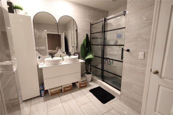 Bathroom, Dual Sink Vanities, Glass Shower, Interior, Marble Walls, Wood Texture Flooring