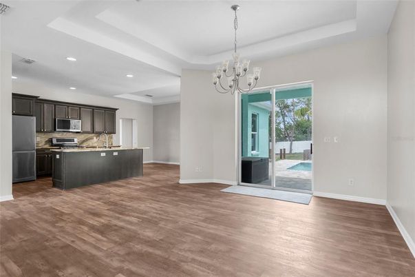 Chandelier, Empty room, Interior, Kitchen, Recessed Lighting, Stainless Steel Appliances, Wood Texture Flooring