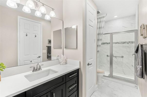 Bathroom, Dual Sink Vanities, Glass Shower, Interior, Marble, Marble Walls, Recessed Lighting