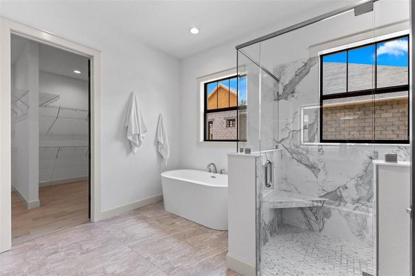 Bathroom, Free Standing Baths, Glass Shower, Interior, Marble, Marble Walls, Recessed Lighting, Wood Texture Flooring