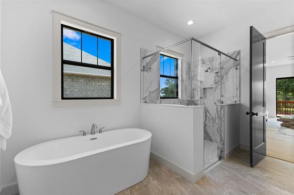 Bathroom, Free Standing Baths, Glass Shower, Interior, Marble Walls, Recessed Lighting, Wood Texture Flooring
