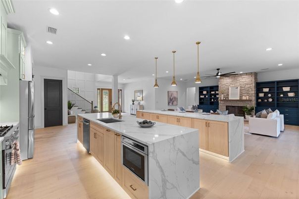 Fireplace, Interior, Kitchen, Living room, Pendant Lights, Recessed Lighting, Stainless Steel Appliances, Stone Walls, Wood Texture Flooring