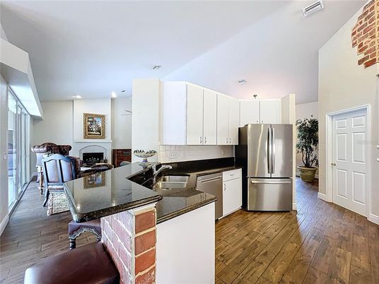 Fireplace, Interior, Kitchen, Recessed Lighting, Stainless Steel Appliances, Wood Texture Flooring