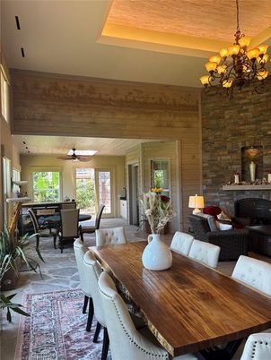 Chandelier, Dining room, Fireplace, Interior, Living room, Stone Walls