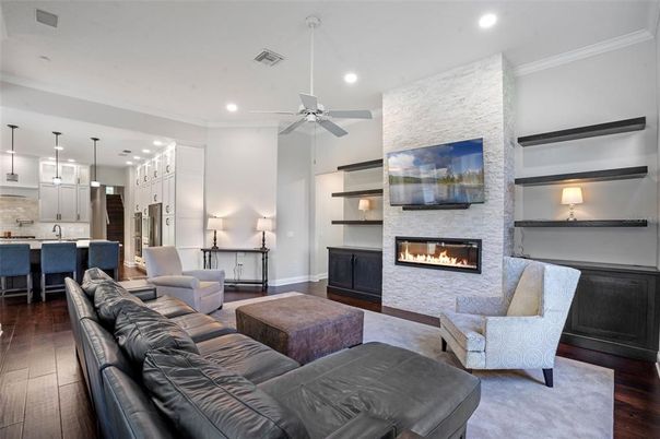Fireplace, Interior, Kitchen, Living room, Pendant Lights, Recessed Lighting, Stainless Steel Appliances, Stone Walls, Wood Texture Flooring