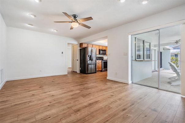Empty room, Interior, Kitchen, Recessed Lighting, Stainless Steel Appliances, Wood Texture Flooring