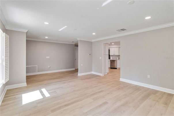 Empty room, Interior, Kitchen, Recessed Lighting, Stainless Steel Appliances, Wood Texture Flooring