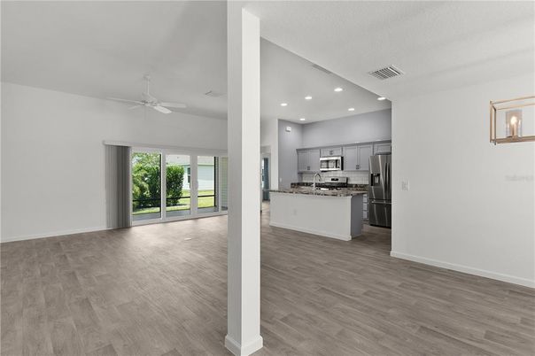 Empty room, Interior, Kitchen, Recessed Lighting, Stainless Steel Appliances, Wood Texture Flooring