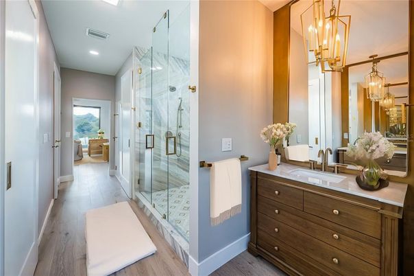 Bathroom, Chandelier, Glass Shower, Interior, Marble Walls, Pendant Lights, Recessed Lighting, Wood Texture Flooring