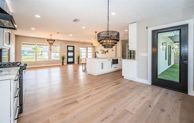 Chandelier, Interior, Kitchen, Pendant Lights, Recessed Lighting, Stainless Steel Appliances, Wood Texture Flooring